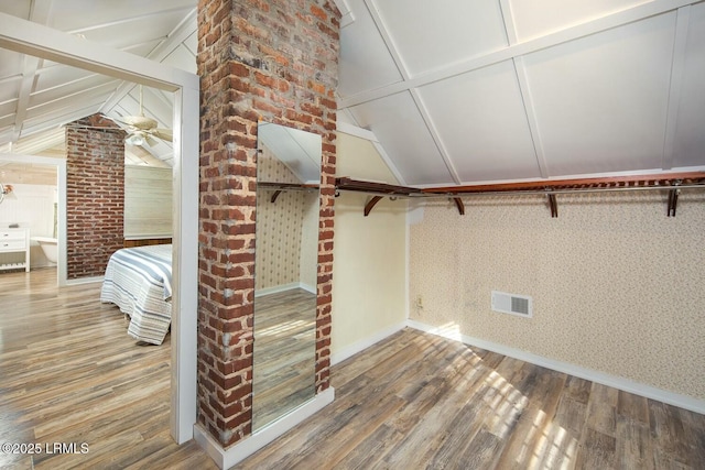 walk in closet featuring lofted ceiling and wood-type flooring