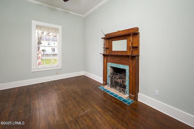 unfurnished living room featuring crown molding, ceiling fan, a fireplace, and dark wood-type flooring