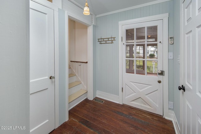 doorway to outside with ornamental molding and dark wood-type flooring