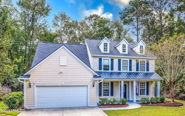 view of front of home with a garage, a front yard, and a porch