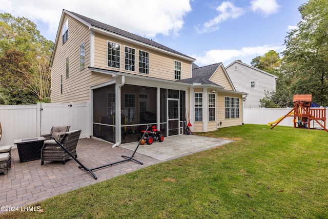 back of house featuring a yard, a playground, a patio area, and a sunroom