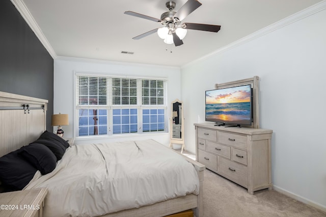 bedroom with ornamental molding, light colored carpet, and ceiling fan