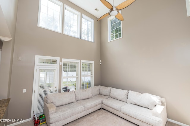 carpeted living room featuring ceiling fan