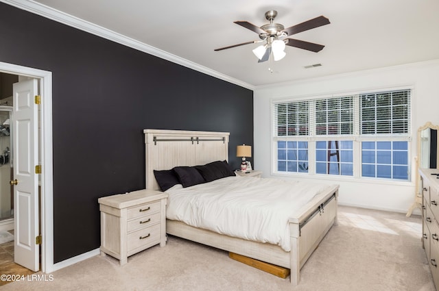 bedroom with light carpet, ornamental molding, and ceiling fan