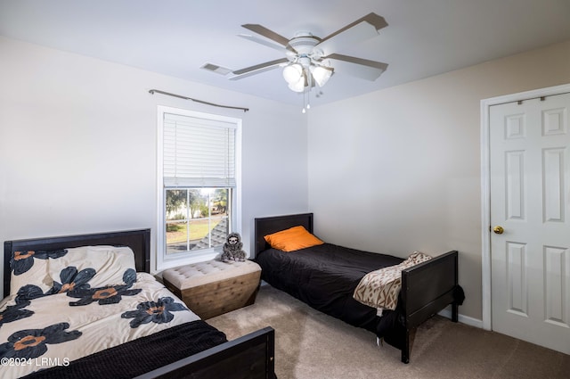 bedroom with ceiling fan and light carpet