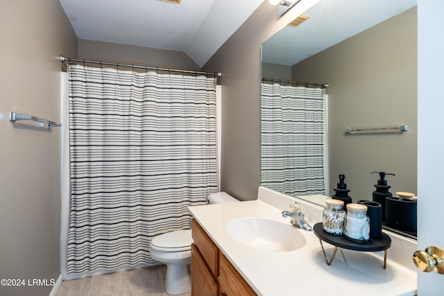 bathroom featuring lofted ceiling, tile patterned flooring, vanity, curtained shower, and toilet