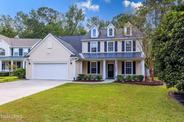 view of front of property with a garage, covered porch, and a front yard