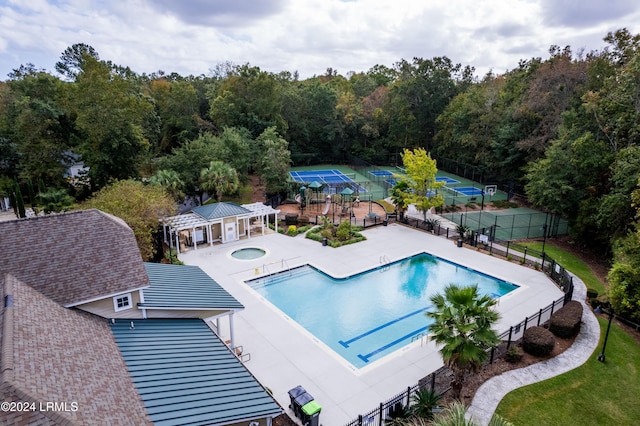 view of swimming pool with an in ground hot tub and a patio area