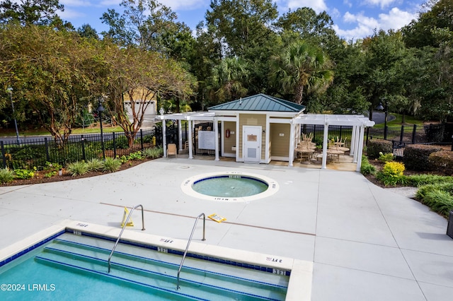 view of swimming pool with a hot tub, a patio, and a pergola