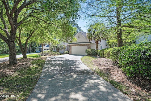 122 Island W Dr, Bluffton, SC 29910 - obstructed view of property featuring concrete driveway, brick siding, and a garage