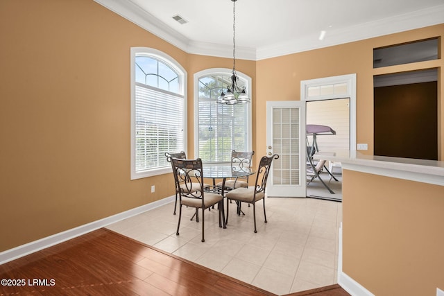 122 Island W Dr, Bluffton, SC 29910 - dining space with visible vents, ornamental molding, light tile patterned flooring, baseboards, and a chandelier