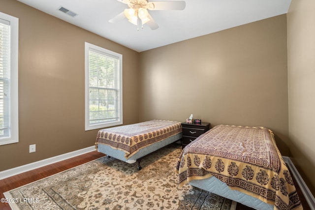 122 Island W Dr, Bluffton, SC 29910 - bedroom featuring baseboards, wood finished floors, visible vents, and ceiling fan