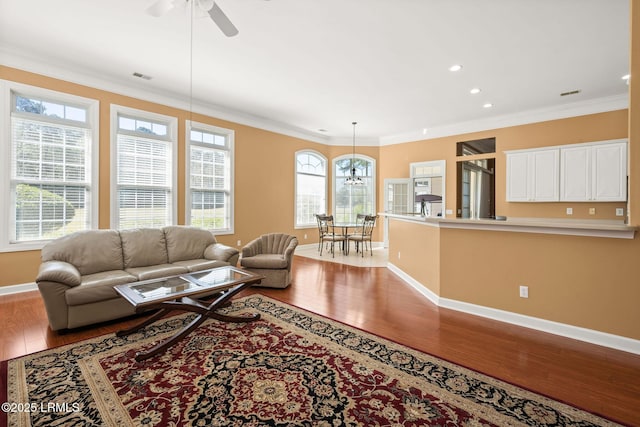 122 Island W Dr, Bluffton, SC 29910 - living room featuring wood finished floors, a healthy amount of sunlight, baseboards, and ceiling fan