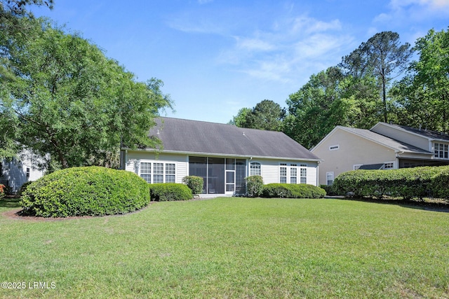 122 Island W Dr, Bluffton, SC 29910 - view of front facade featuring a sunroom and a front yard