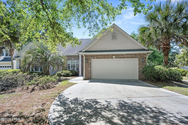 122 Island W Dr, Bluffton, SC 29910 - view of front of house featuring an attached garage, driveway, and brick siding