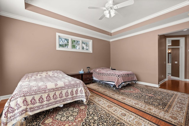 122 Island W Dr, Bluffton, SC 29910 - bedroom with baseboards, wood finished floors, and a tray ceiling