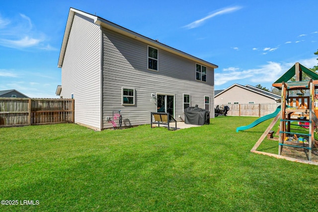 back of property featuring a patio area, a yard, a playground, and a fenced backyard