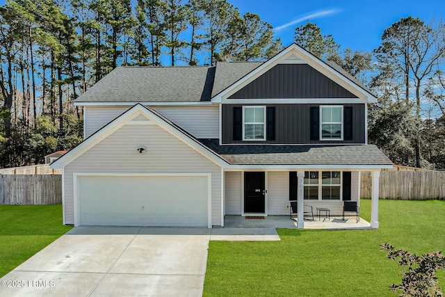 traditional home featuring driveway, fence, and a front yard