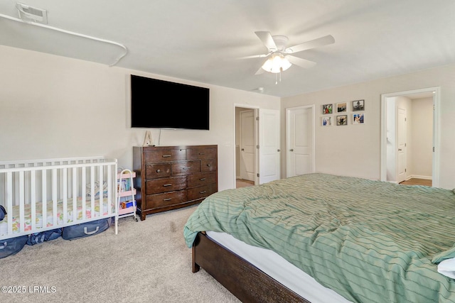 bedroom featuring light carpet, ceiling fan, and visible vents