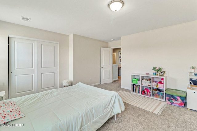 bedroom with baseboards, visible vents, a closet, and light colored carpet