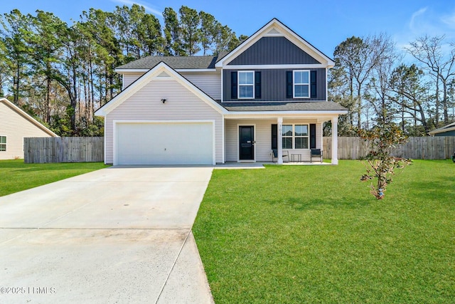 traditional-style house featuring a porch, concrete driveway, fence, and a front lawn