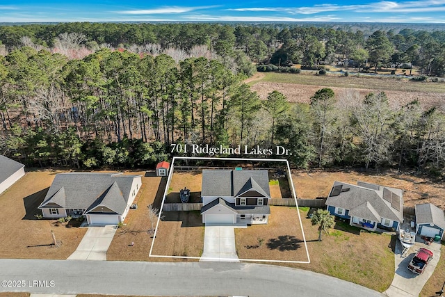 birds eye view of property with a forest view