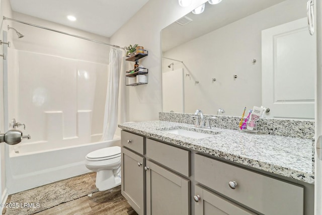 full bathroom with toilet, wood finished floors, visible vents, vanity, and shower / bath combination with curtain