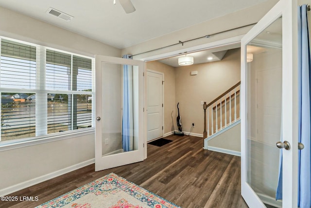 entrance foyer featuring visible vents, dark wood finished floors, stairway, and baseboards