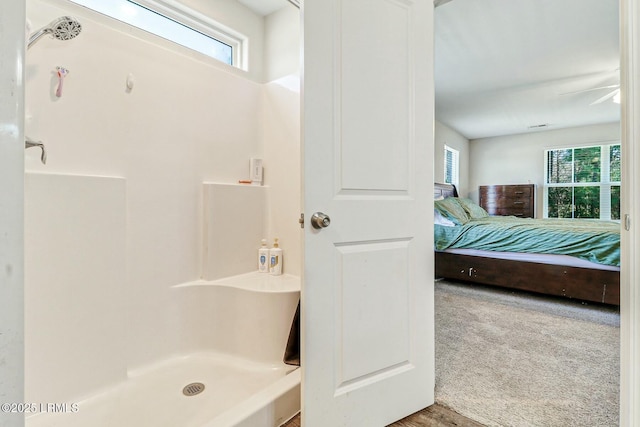 ensuite bathroom featuring a stall shower and connected bathroom