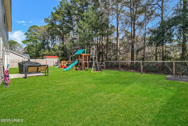 view of yard with a fenced backyard and a playground