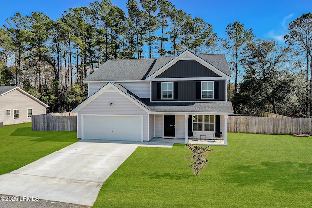 traditional-style house featuring concrete driveway, covered porch, fence, a front lawn, and board and batten siding