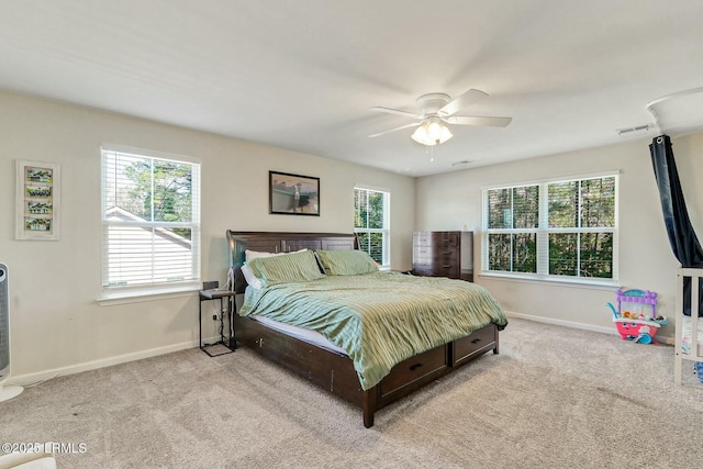 bedroom with light carpet, multiple windows, and visible vents