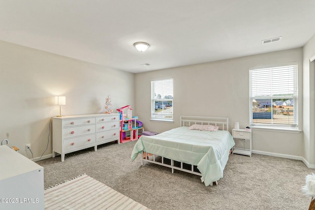 carpeted bedroom with visible vents and baseboards