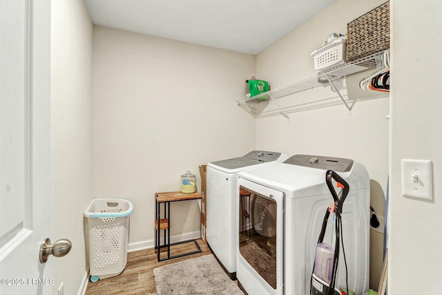 laundry area with laundry area, light wood-style flooring, baseboards, and independent washer and dryer