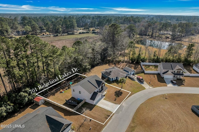 drone / aerial view with a residential view and a wooded view