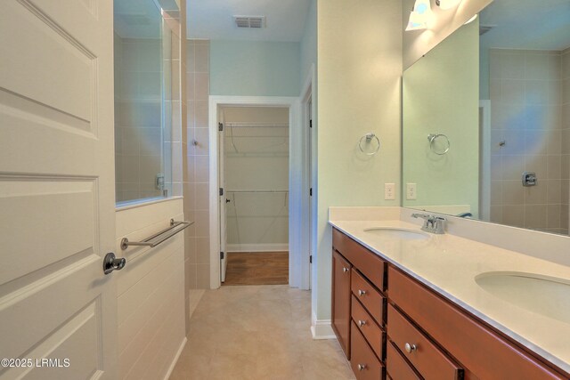 54 Slash Pine Dr, Okatie, SC 29909 - bathroom featuring double vanity, visible vents, a tile shower, and a sink