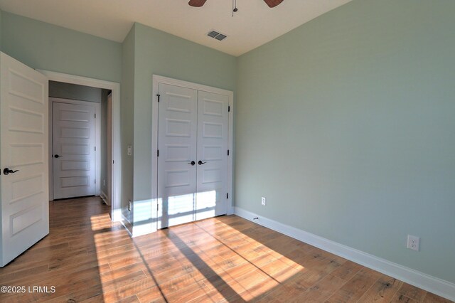 54 Slash Pine Dr, Okatie, SC 29909 - unfurnished bedroom featuring visible vents, a closet, wood finished floors, baseboards, and ceiling fan