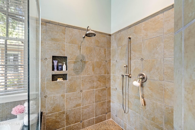 full bath with a tile shower
