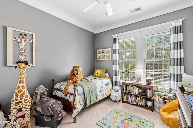 carpeted bedroom with ornamental molding and ceiling fan