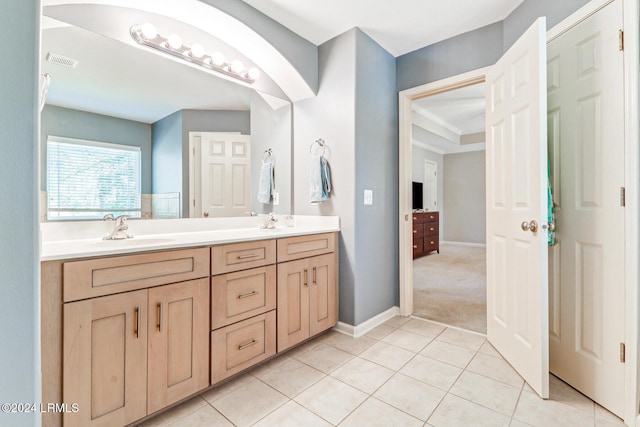 bathroom with crown molding, tile patterned floors, and vanity