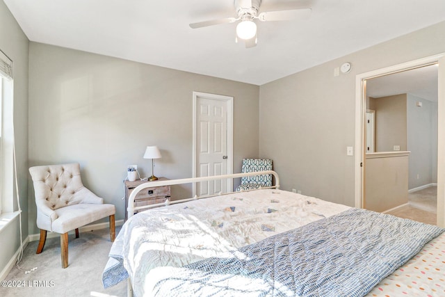 carpeted bedroom featuring ceiling fan and baseboards