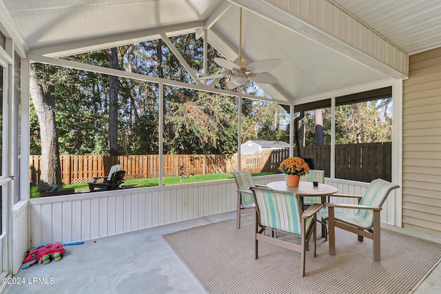 sunroom / solarium with lofted ceiling and ceiling fan