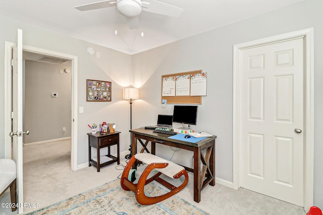 carpeted office space with ceiling fan