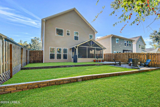 back of house with a patio, a sunroom, and a lawn