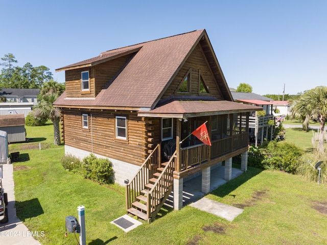 rear view of property featuring a sunroom and a yard