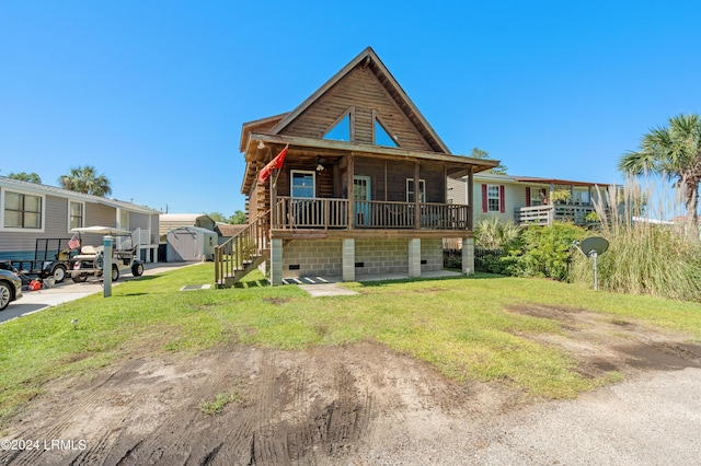 log-style house featuring a front yard and covered porch