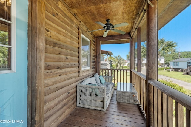 wooden deck featuring ceiling fan and an outdoor living space