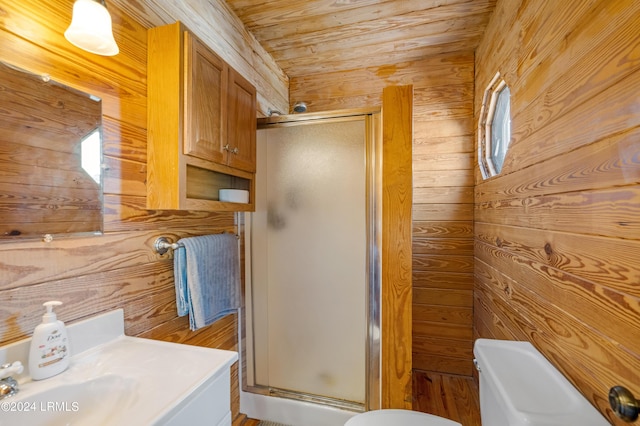 bathroom featuring wooden walls, a shower with door, and toilet