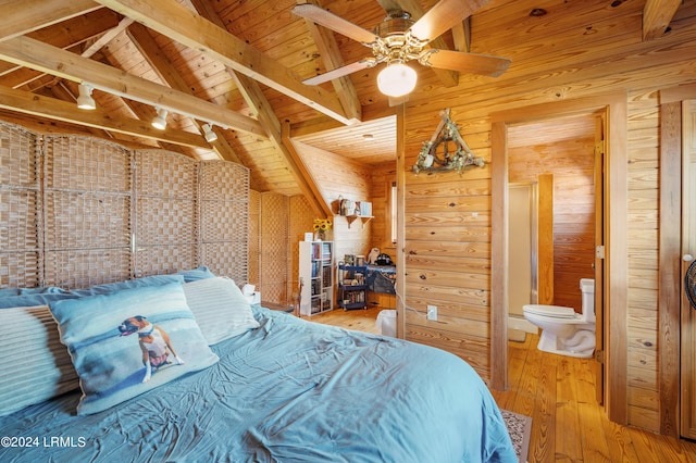 bedroom featuring connected bathroom, wooden walls, wood-type flooring, wooden ceiling, and beam ceiling