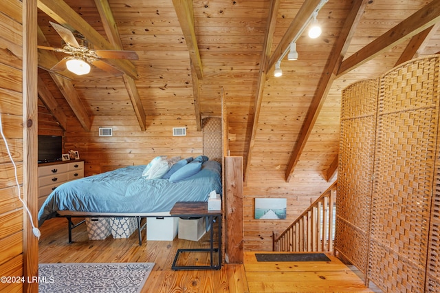 bedroom with wood ceiling, hardwood / wood-style flooring, ceiling fan, lofted ceiling with beams, and wood walls